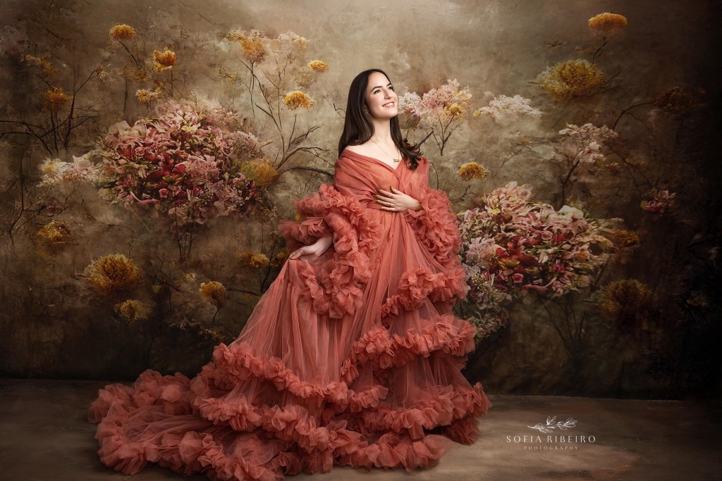 new jersey sweet 16 photographer captures a young girl in a dramatic gown against a floral backdrop