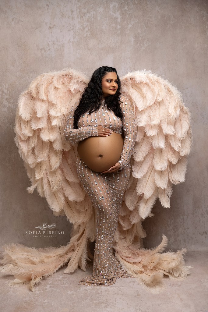 mom is framed in jewels and angel wings for maternity portraits in nj