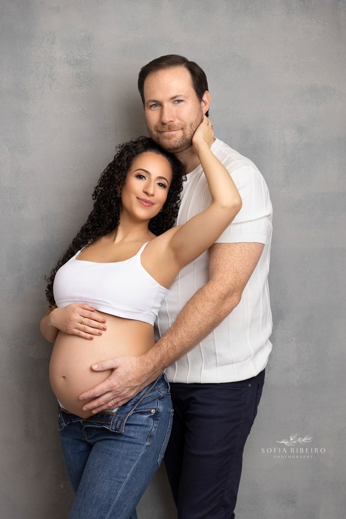 mom and dad share a sweet pose together in matching jeans looks