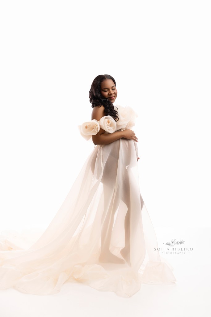 an ethereal portrait of mom to be in a sheer white gown for her maternity portraits in nj

