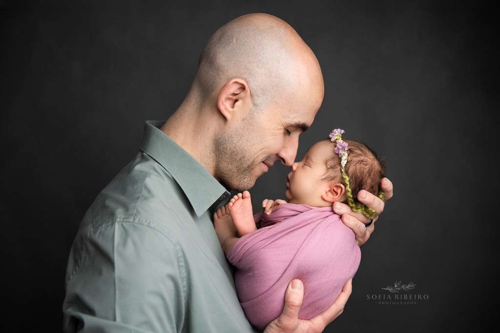 dad shares a snuggle with his new baby during newborn photos with nj