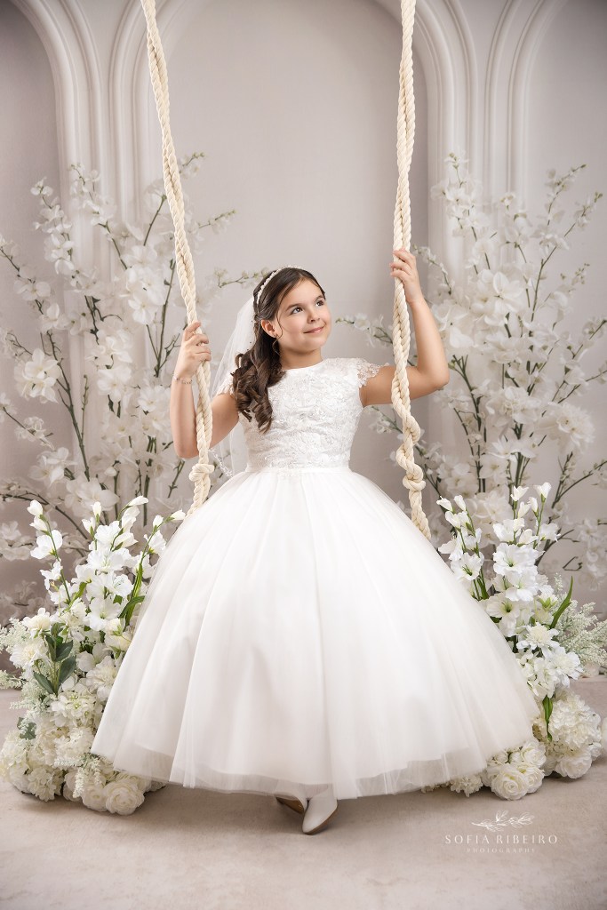 nj communion photographer captures a communion portrait on a floral swing