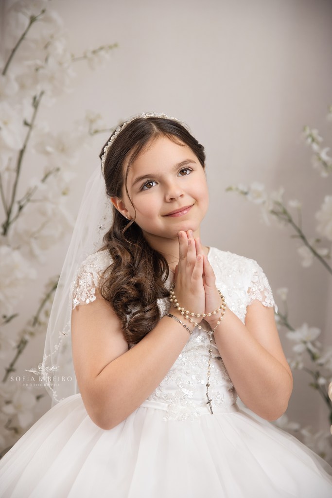 a formal portrait of a young girl celebrating her first holy communion with a nj communion photographer