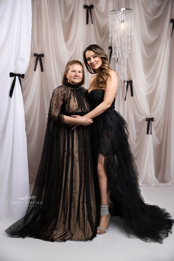 mother and daughter pose for formal photos together, mother and grandmother in matching black gowns