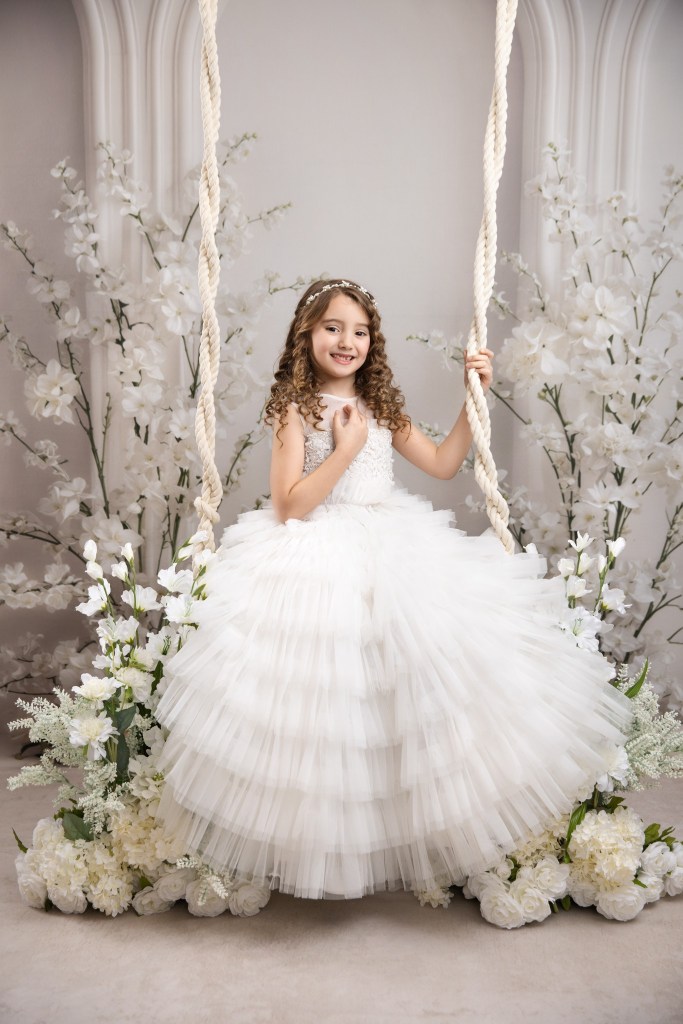 nj communion photography, girl on a swing against a floral backdrop