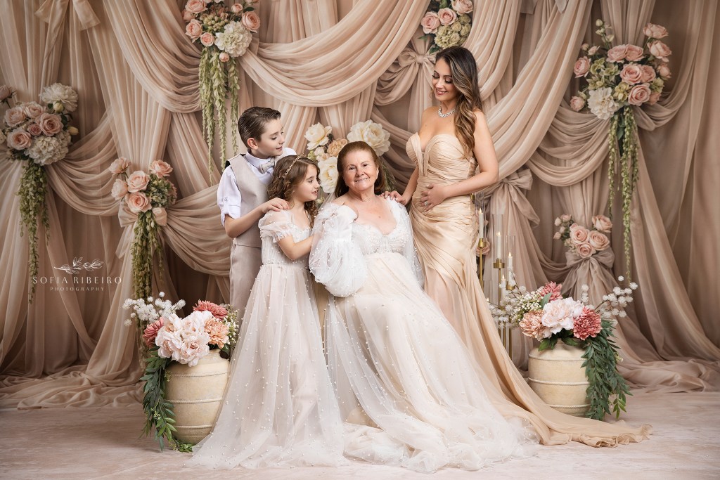 a three generation mom grandmother and children portrait shot against a beige draped backdrop in tones of cream and beige