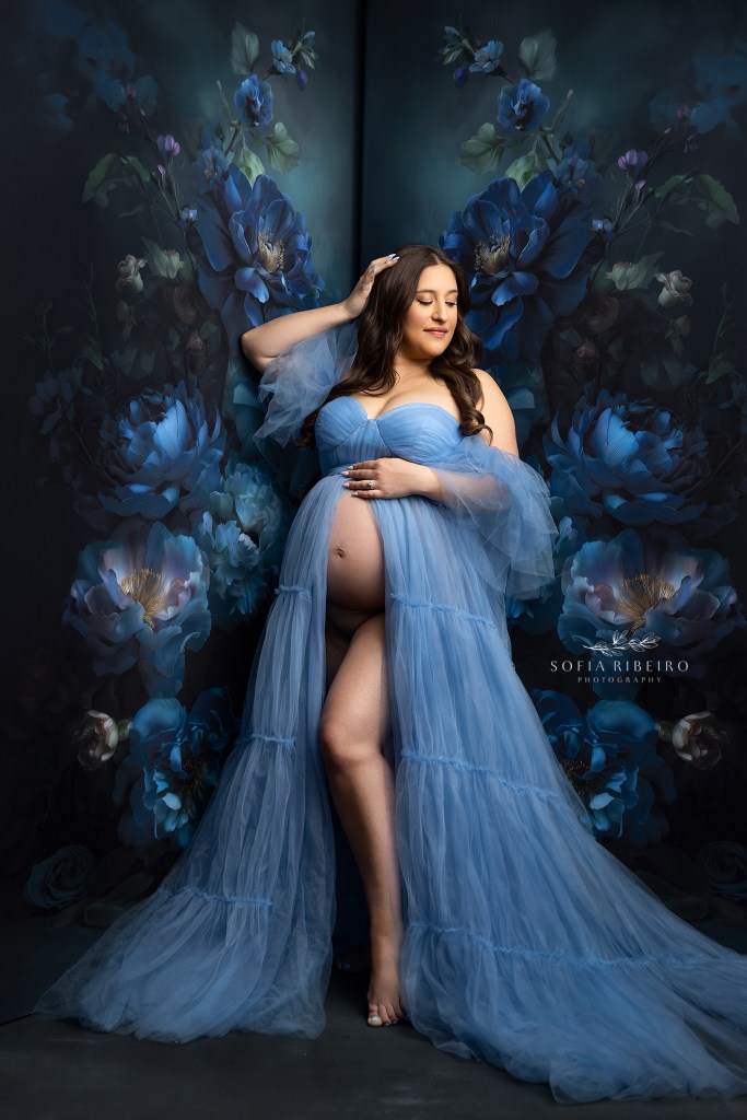 navy and light blue tones marry together in this maternity portrait with a floral backdrop