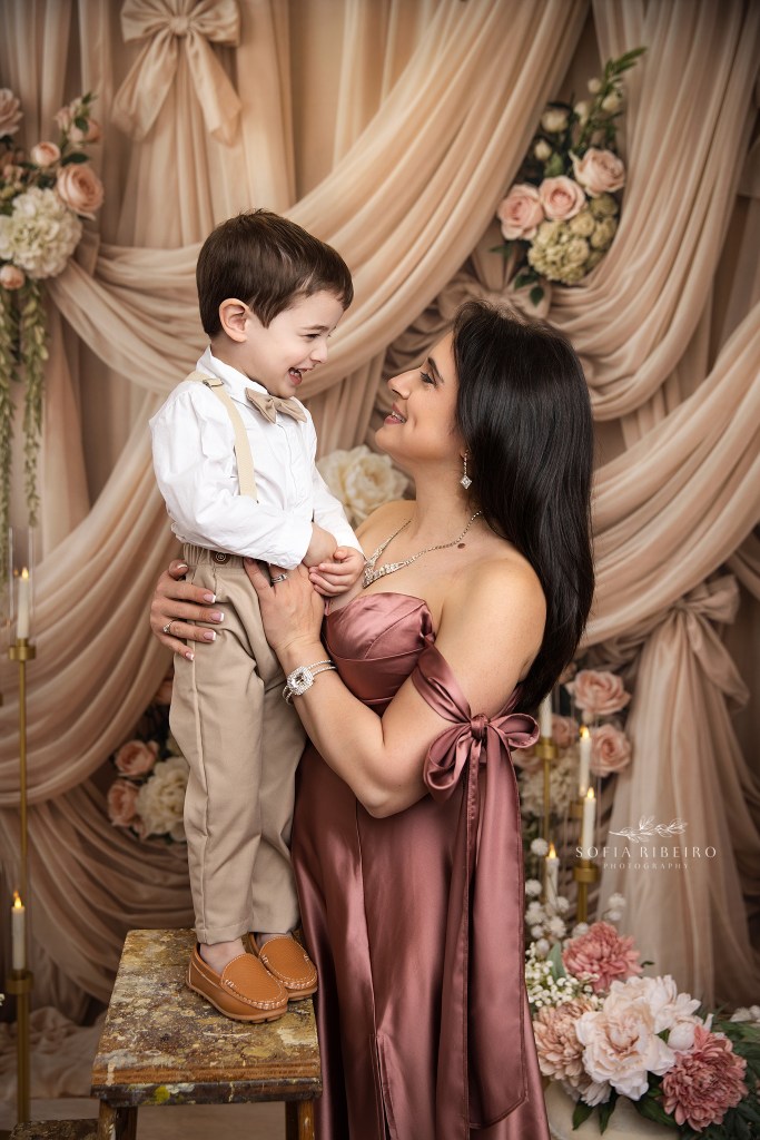 mom and her youngest child share a sweet smile to each other during photos in a nj portrait studio