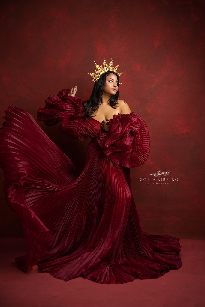 nj empowerment photographer captures woman in red pleated gown and a crown
