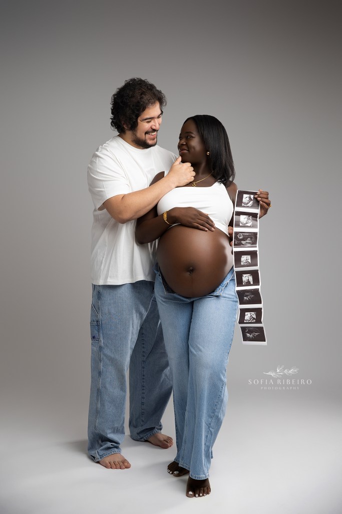 mom and dad pose together in matching denim looks for maternity photos with sonogram