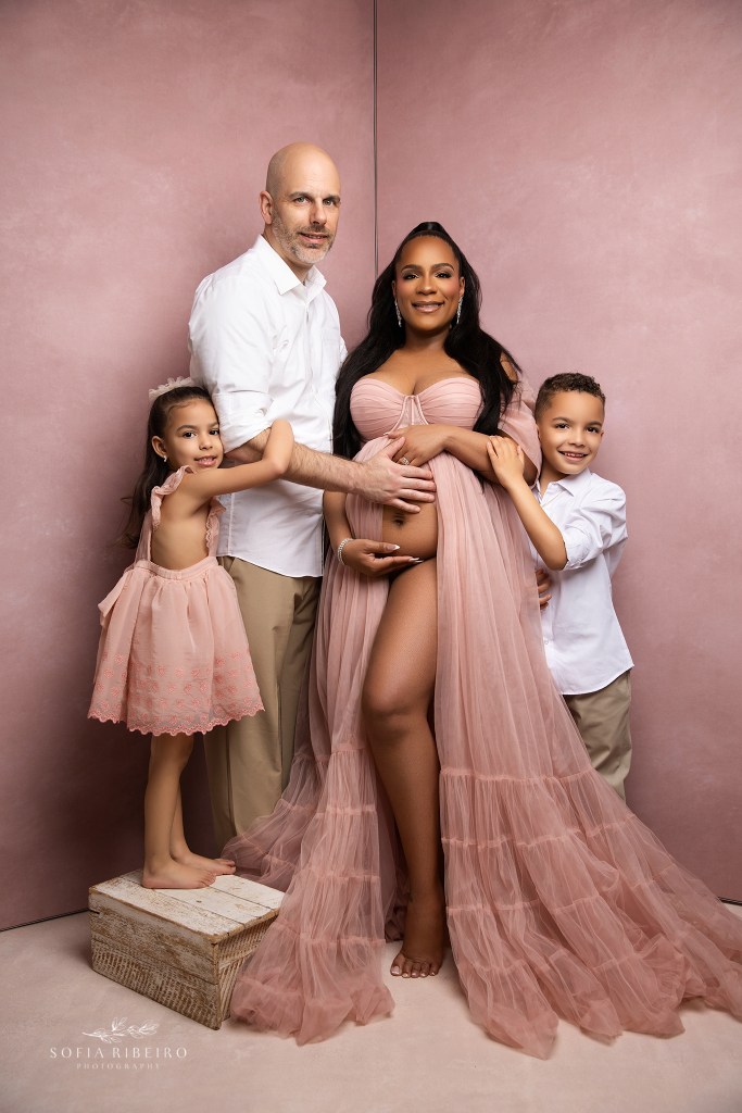 a family portrait celebrating baby to be during maternity photos in new jersey