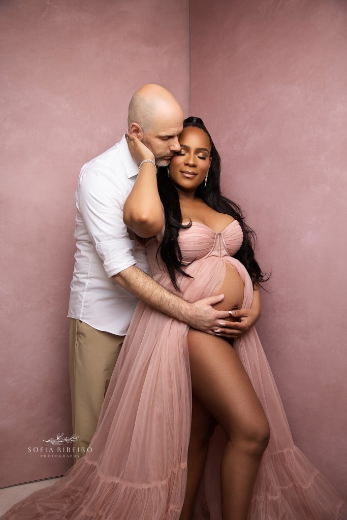 mom and dad share a special moment together during maternity portraits in an nj studio