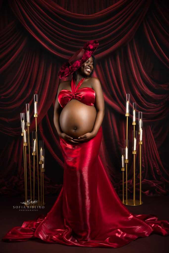 high end maternity photographer in nj captures a mom to be elegantly in red