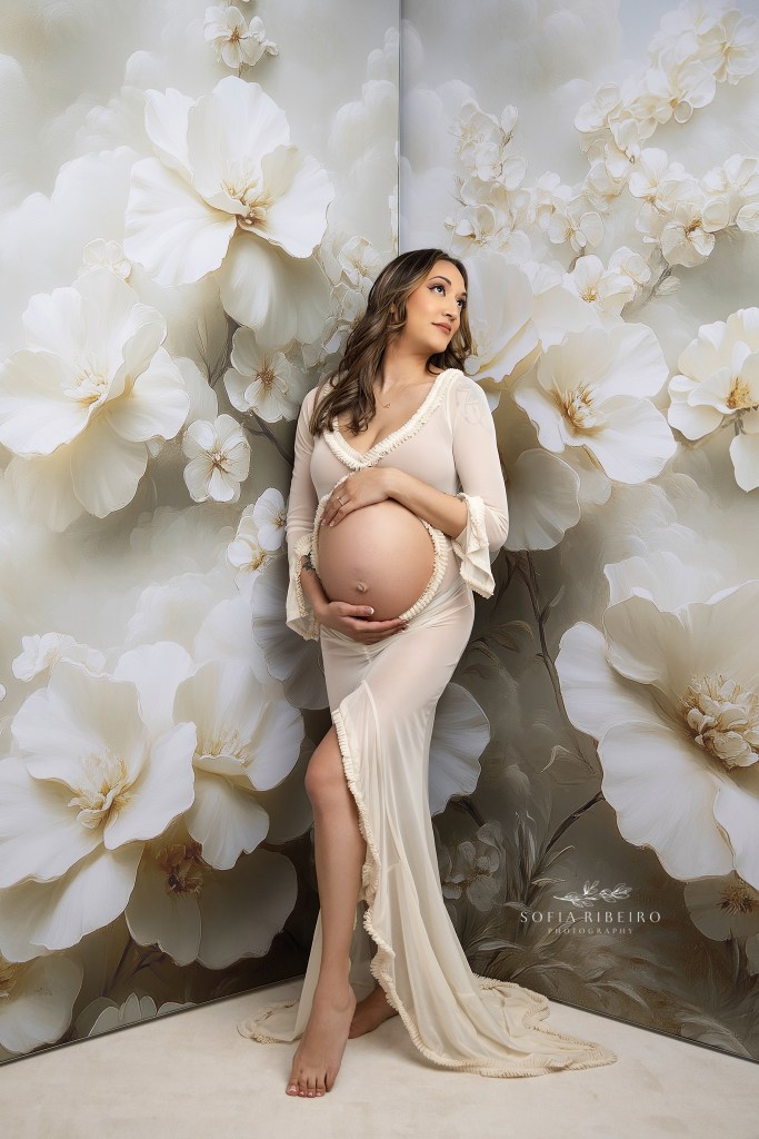 ny maternity photographer captures a mom to be with baby bump exposed against a floral backdrop
