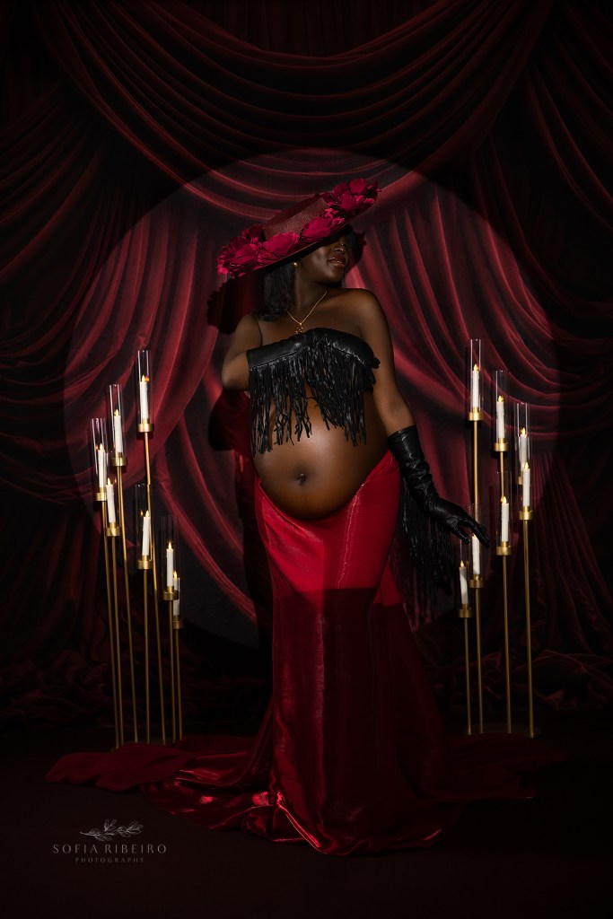 a sultry maternity photo in shades of red with dynamic lighting in a nj maternity photography studio
