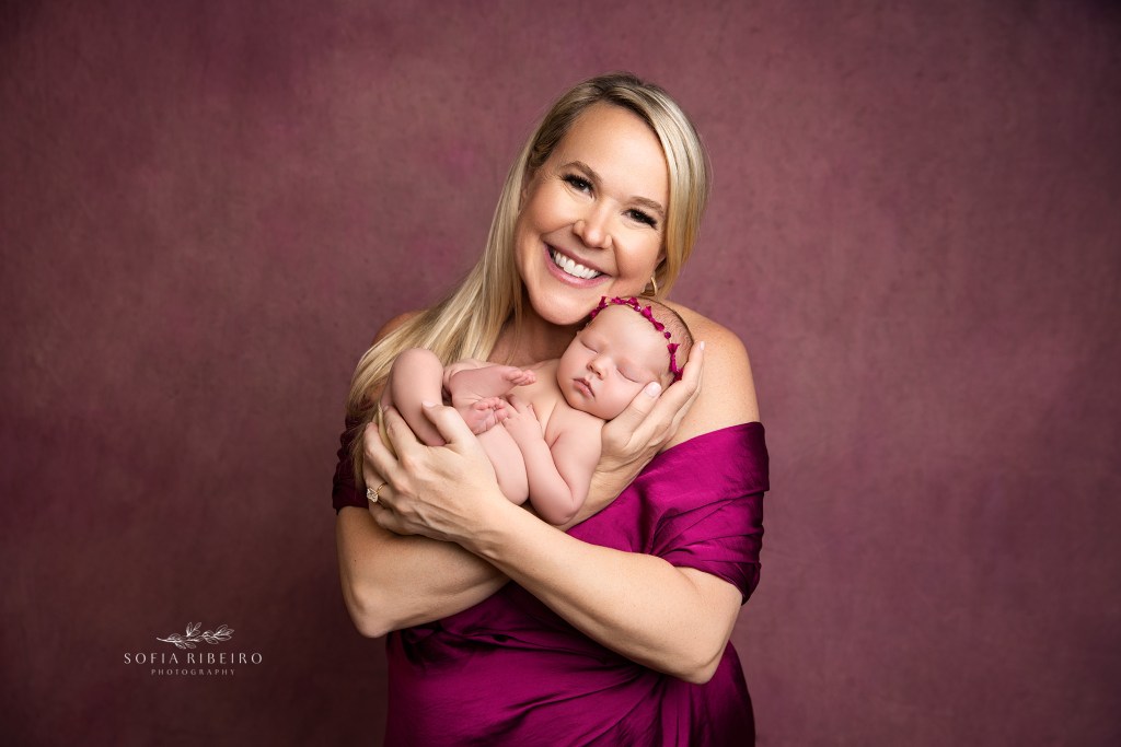 mom poses with her newborn daughter