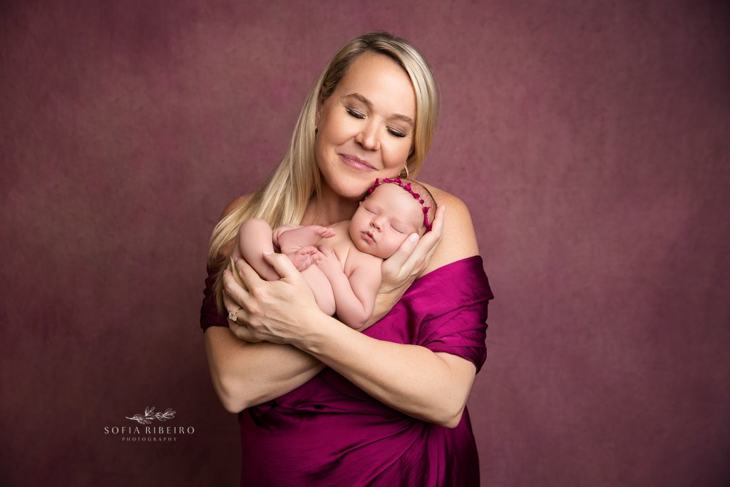 mom poses with her newborn daughter