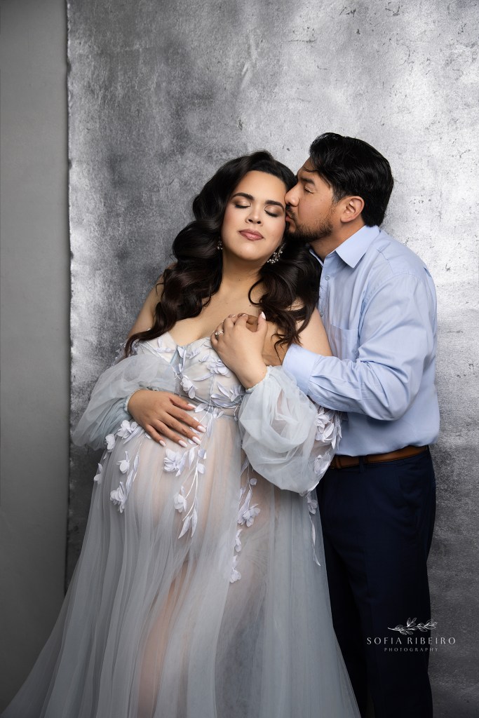 mom and dad share a sweet moment in shimmery silver and light blue tones