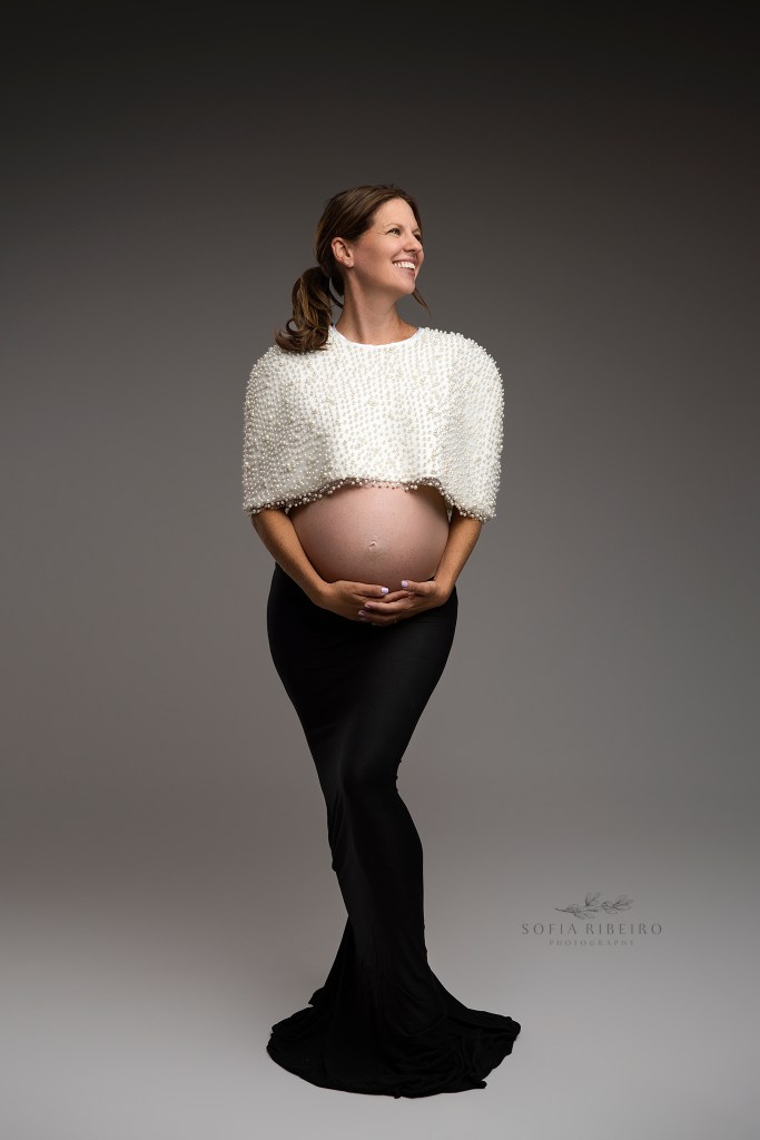 a modern, colorblock outfit with pearl cape and black skirt for maternity portraits
