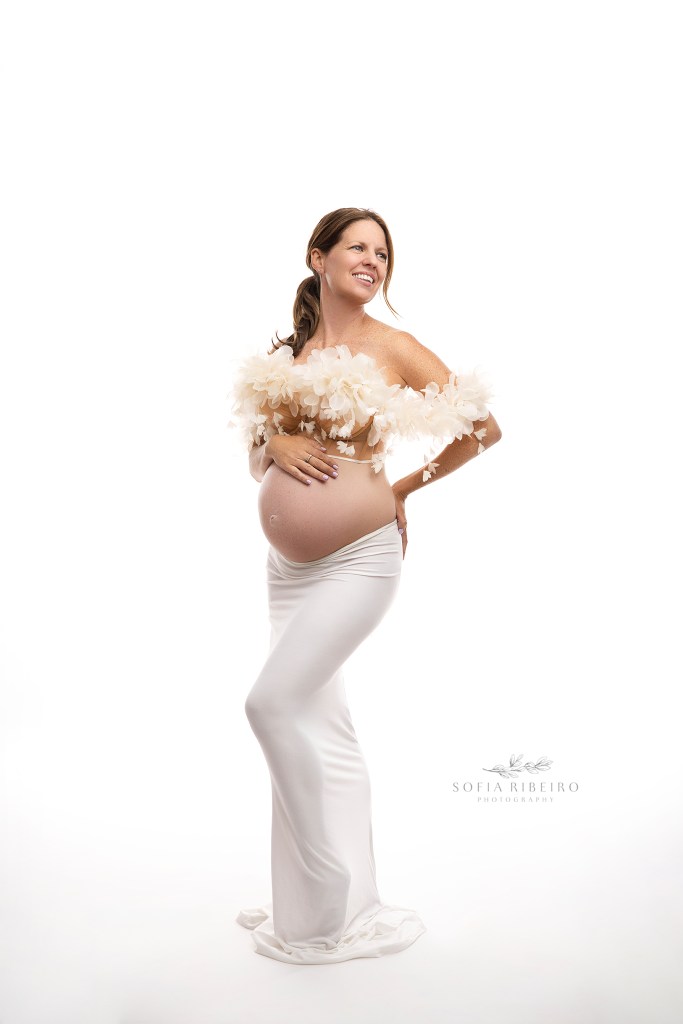 nj maternity photographer captures mom in an all white look with soft petaled bustier