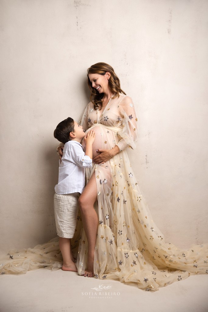 a shared snuggle with her son while cradling the baby bump