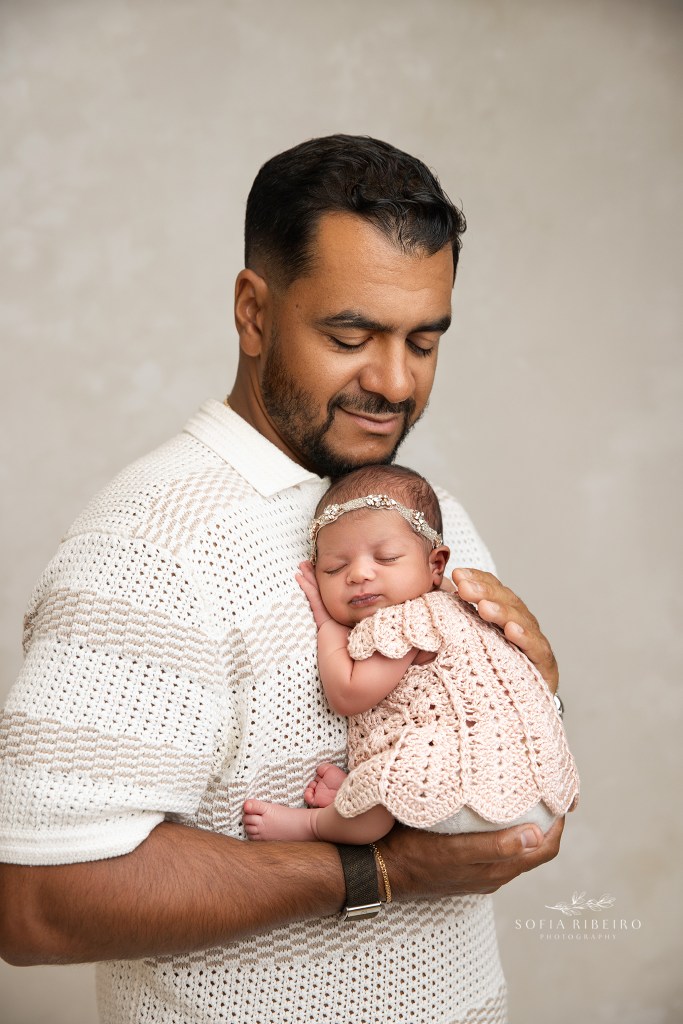 dad poses lovingly with his baby girl
