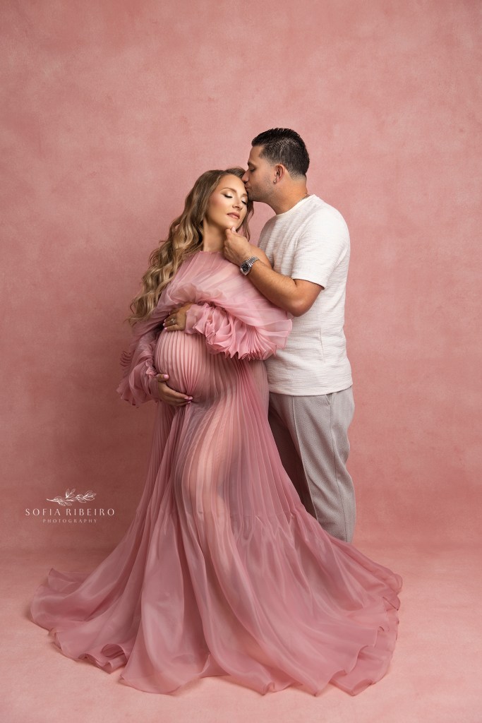 mom and dad share a sweet moment during maternity portraits at sofia ribeiro's nj studio