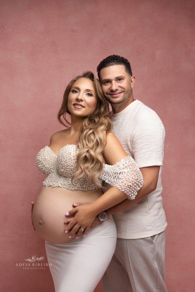 couples fine art maternity photography in pink and white