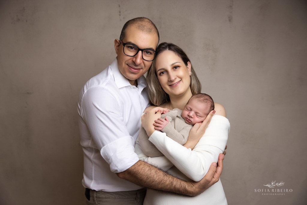 parents snuggle their baby boy warmly
