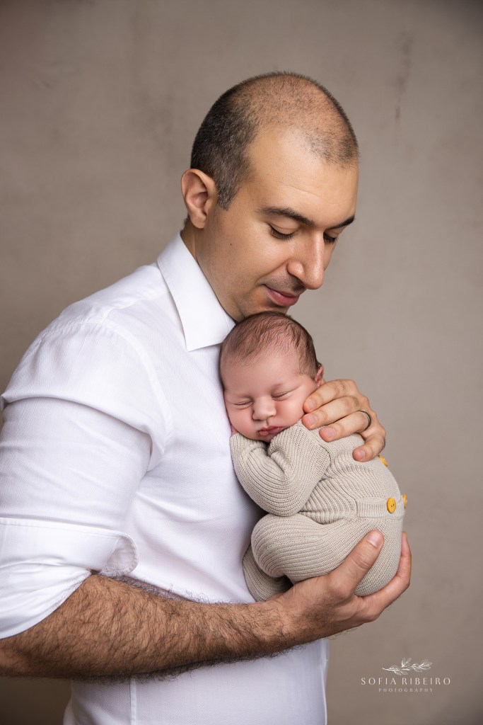 dad shares a snuggle with his newborn son