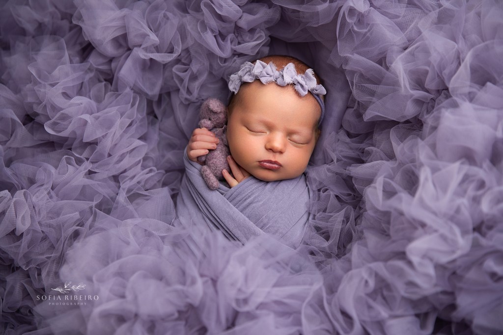nj newborn photography studio focuses on fine art baby photos, baby girl swaddled in purple