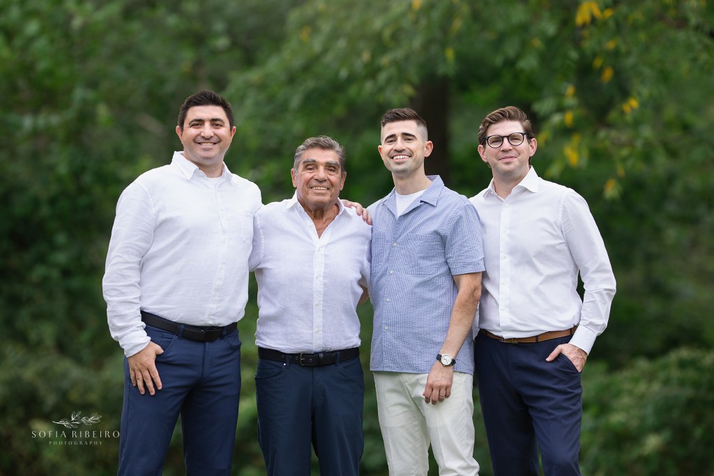 dad is posed with his three adult sons for family photos celebrating his 80th birthday