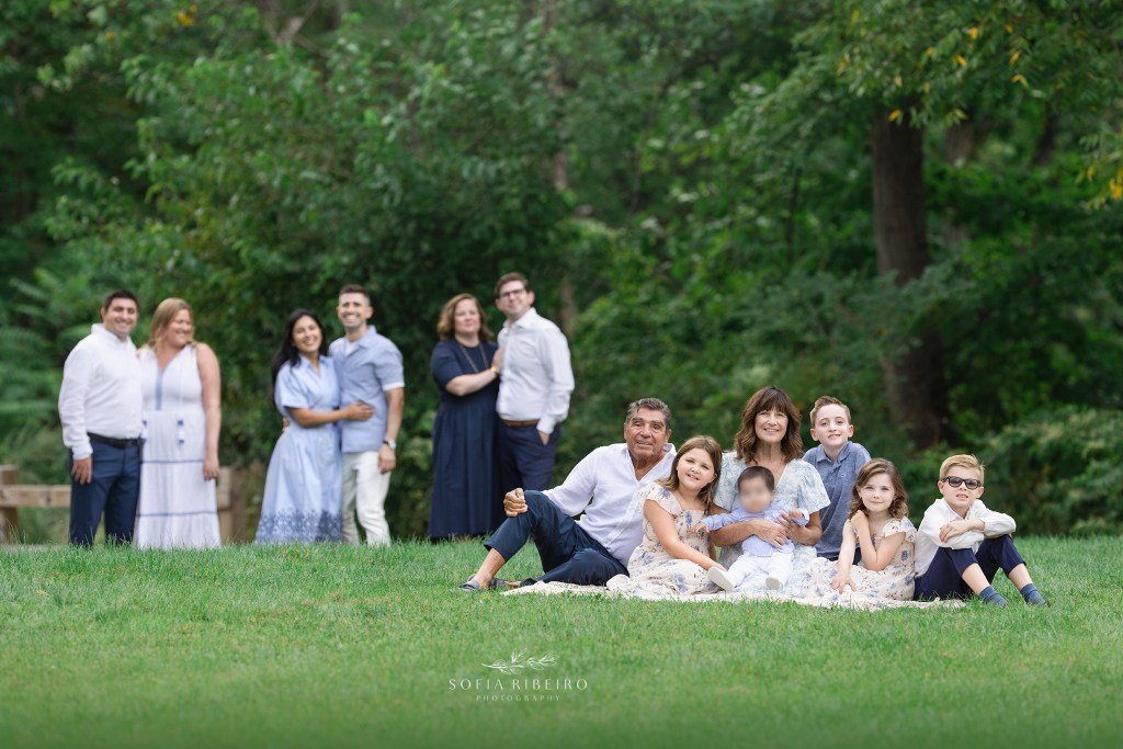 seated family portrait with parents in the background