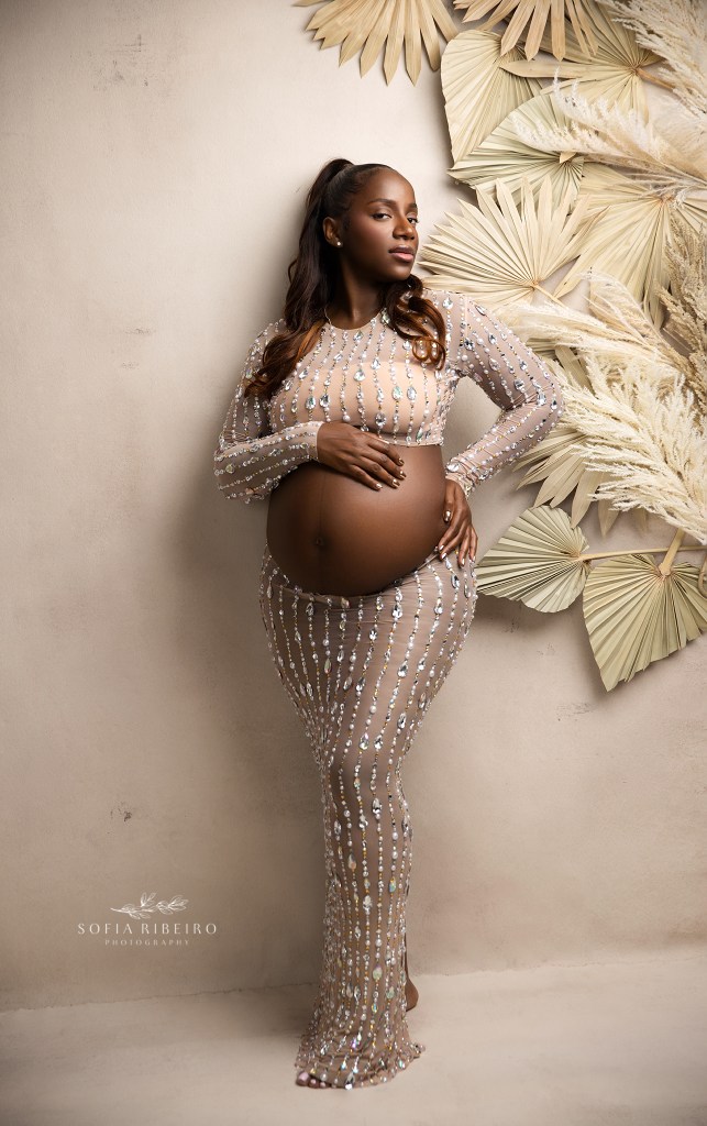 a sparkling two piece outfit highlights moms baby bump